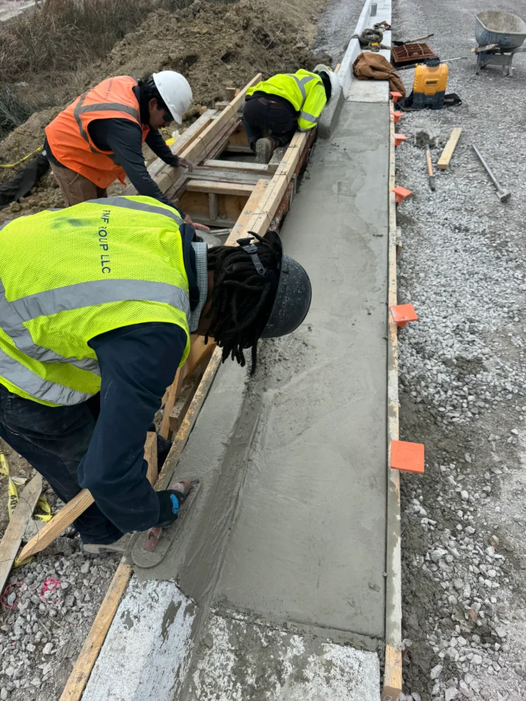 Workers for FMF Group LLC pouring concrete